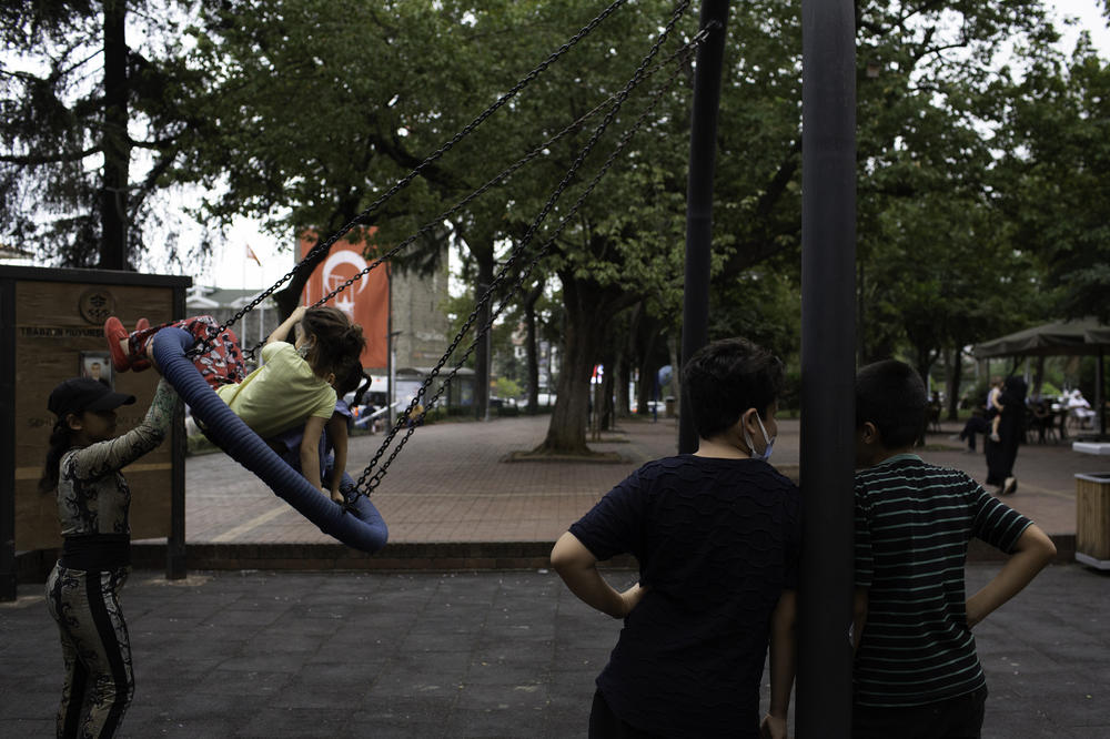 Children ride on a swing in Atapark, a park frequented by the Afghan community in Trabzon, Turkey.