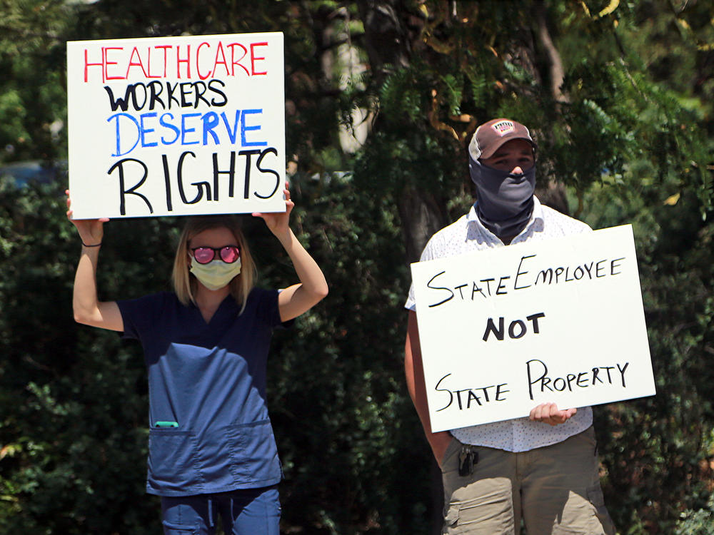 Nurse Katrina Philpot (left) protests against COVID-19 vaccine and mask mandates in Santa Fe, N.M., in August.