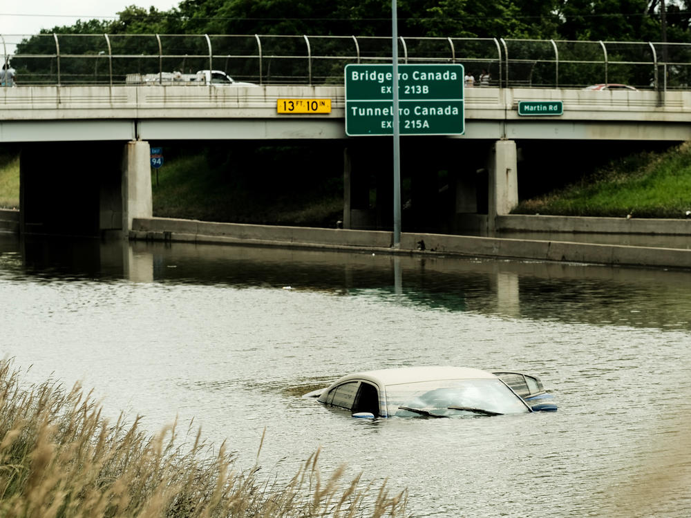 A car is submerged by floodwaters on a portion of I-94 in Detroit, several days after heavy rains flooded parts of the city in June.