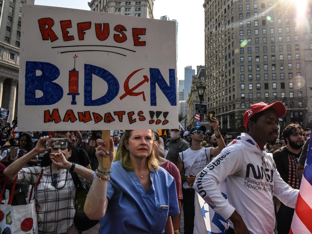 Demonstrators protest COVID-19 vaccine mandates in New York this week. Attitudes among health care workers about getting vaccinated have largely mirrored data from the general population, researchers have found.