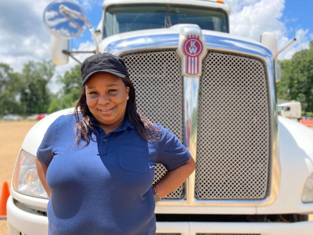 Pamela Williams, a driving instructor with DSC Training Academy, stands in front of one of the academy's trucks on June 29. Williams has been driving for seven years and enjoys seeing the country from the road.