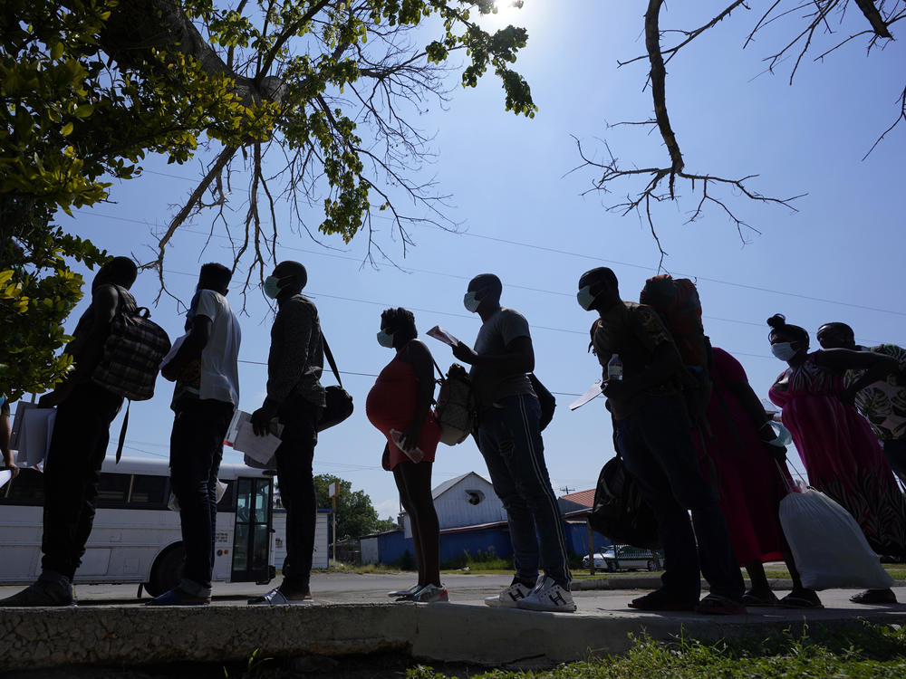 Migrants stand in line at a respite center in June after they crossed the U.S.-Mexico border and turned themselves in and were released in Del Rio, Texas.