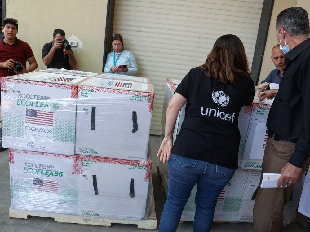 Palestinian Health Ministry staff members in Nablus receive 300,000 doses of COVID-19 vaccines donated by the United States through through the COVAX vaccine-sharing initiative on Aug. 24, 2021.