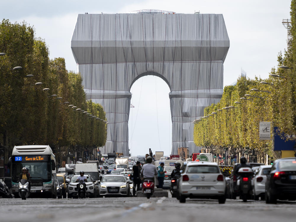 The Arc de Triomphe in Paris is seen wrapped in fabric, in a posthumous art project that is an homage to the late artists Christo and Jeanne-Claude .