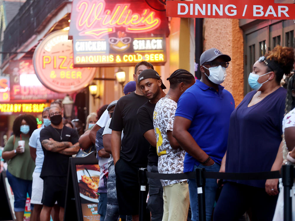 People queue to enter a restaurant in New Orleans' French Quarter in early August.