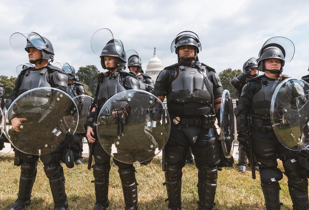 Capitol Police officers form a line in front of the Capitol.