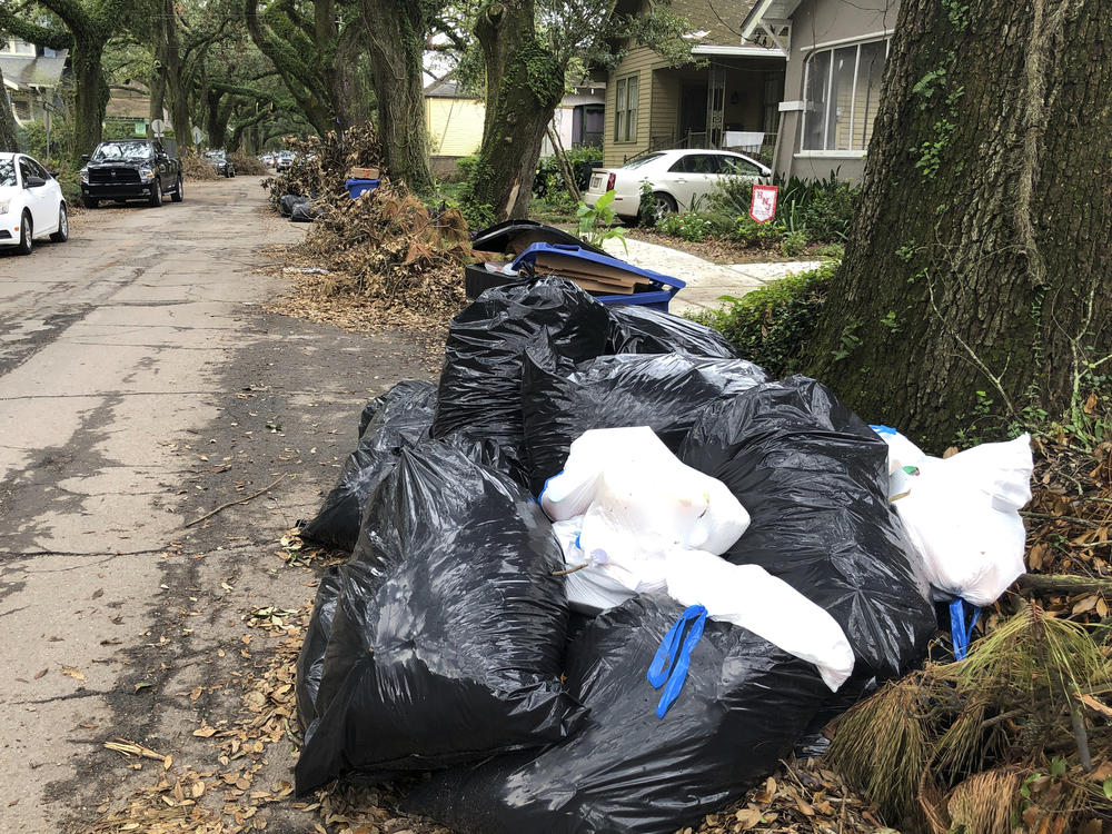 Bags of garbage pile up on a New Orleans street on Friday. Trash collection delays have left some residents outraged at the city's contractors.