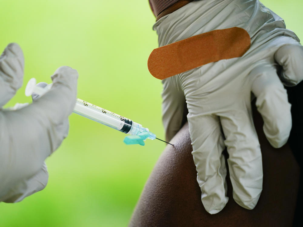 A health worker administers a dose of a Pfizer COVID-19 vaccine during a vaccination clinic earlier this month at the Reading Area Community College in Reading, Pa.