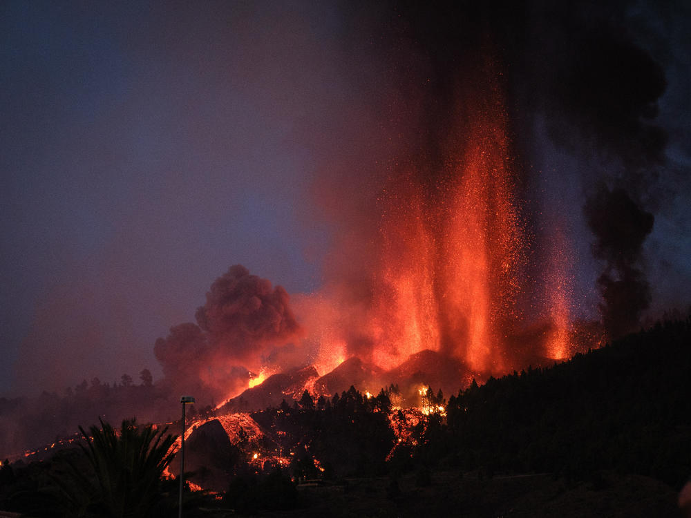 Cumbre Vieja erupts, spewing out columns of smoke, ash and lava, as seen from Los Llanos de Aridane municipality on the Canary island of La Palma on Sunday.
