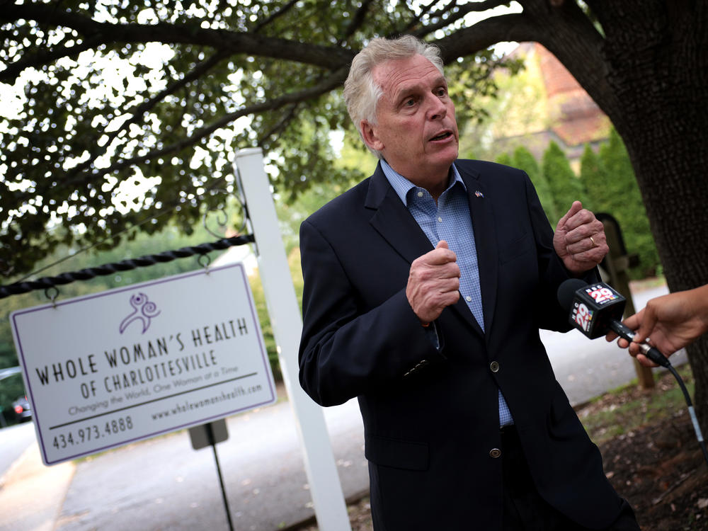 Former Virginia Gov. Terry McAuliffe, a Democrat running for a second term, answers questions from the media after touring Whole Woman's Health of Charlottesville on Sept. 9. He's working to rally voters in response to Texas' restrictive new abortion law.