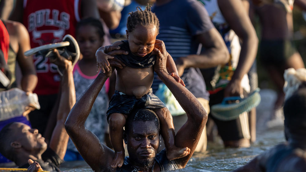 Haitians cross the Rio Grande back into Mexico from Del Rio on Monday. As U.S. authorities began deporting migrants back to Haiti, thousands more waited in a camp in Del Rio and others crossed the river back into Mexico to avoid deportation.