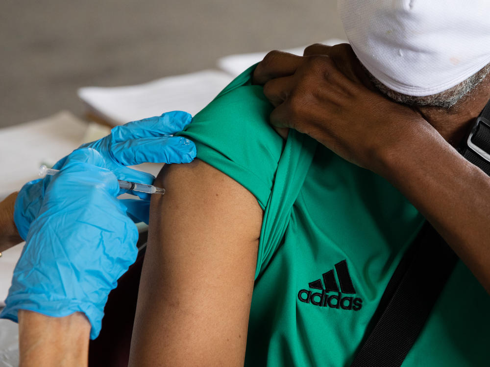 Rufus Peoples receives a dose of the Pfizer-BioNTech COVID-19 vaccine at a vaccination clinic in Southfield, Mich., in August.