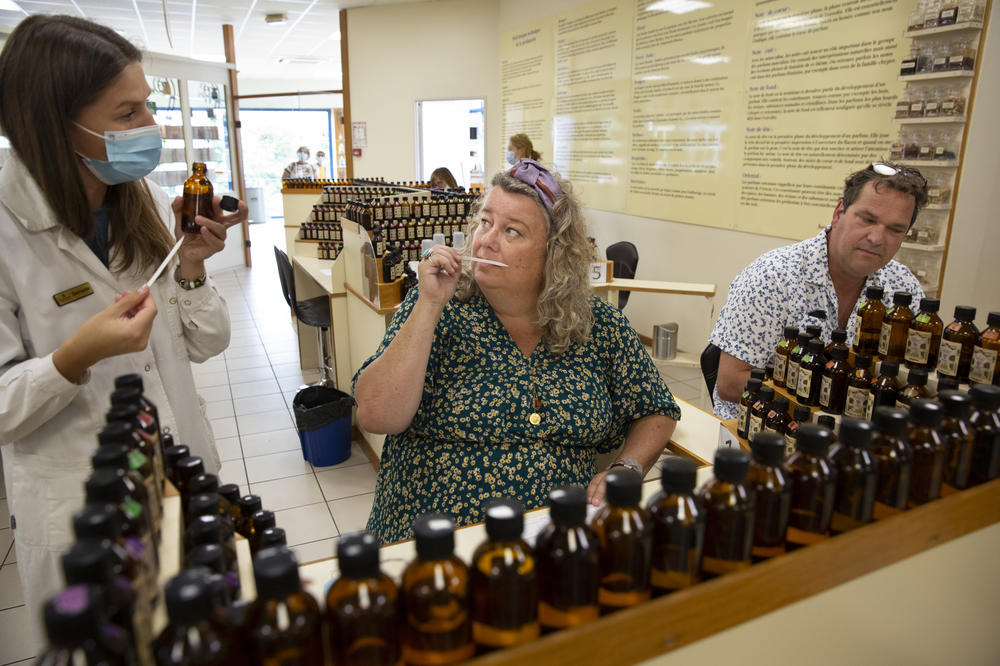 Paul Lokker, 45, and Mariska Lokker, 49, tourists from the Netherlands, try their hand at creating their own fragrance during a workshop at the Galimard Studio des Fragrances in Grasse.