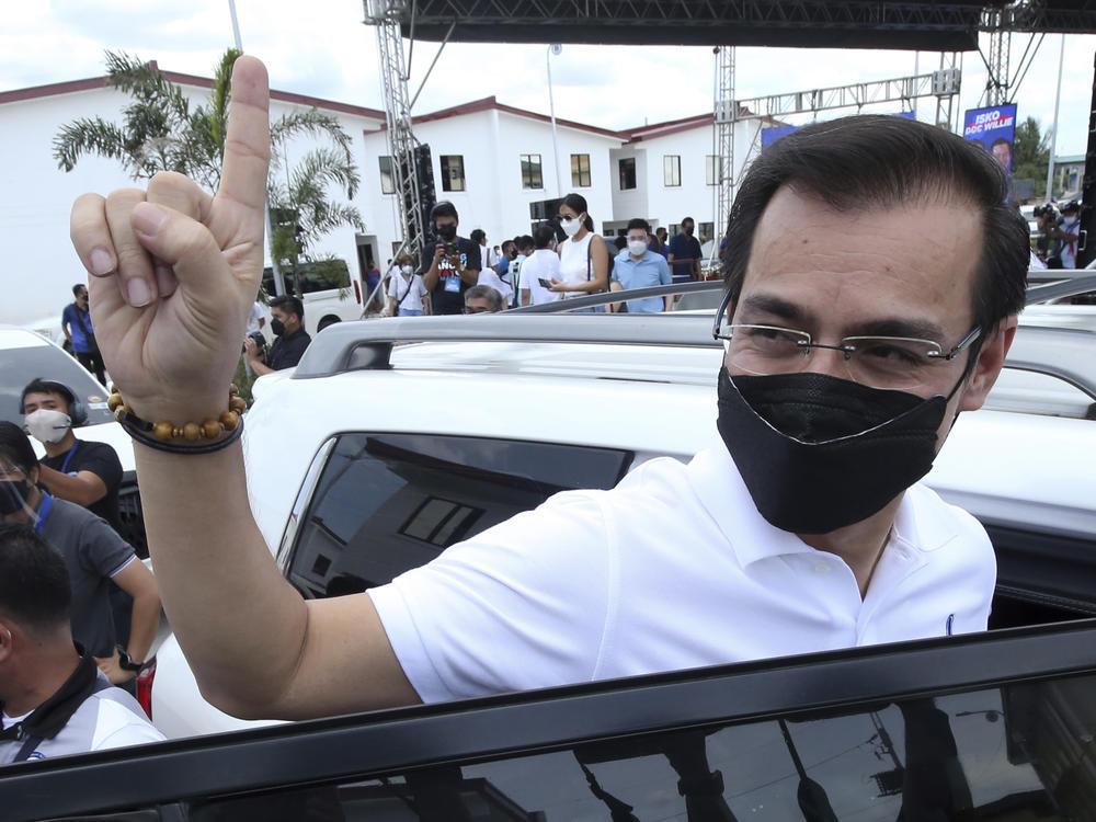 Manila City Mayor Isko Moreno gestures after declaring his bid to run for president in a speech at a public school in the slum area near the place where he grew up in Manila, Philippines on Wednesday Sept. 22, 2021.