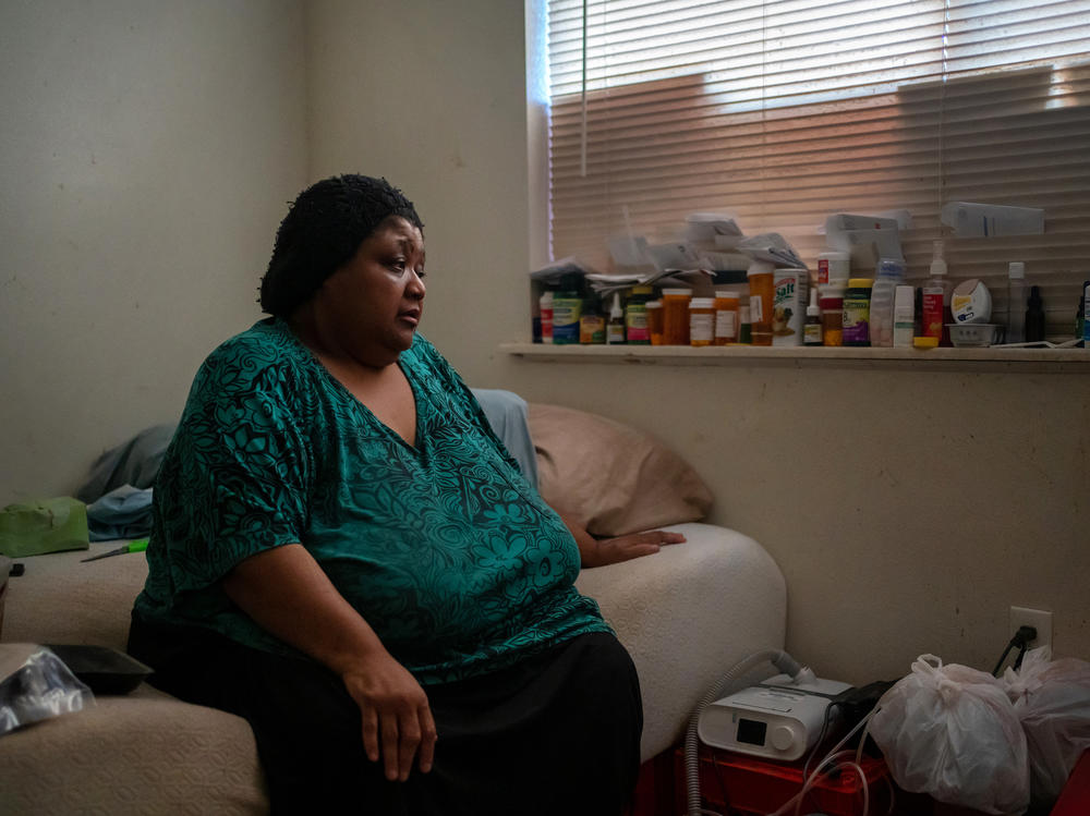 Wilma Banks, who lives in the neighborhood of New Orleans East, sits on her bed next to her nebulizer and CPAP machine. In the aftermath of Hurricane Ida, when much of New Orleans was left without power, she wasn't able to power up the medical devices and had only her limited supply of inhalers to widen her airways.