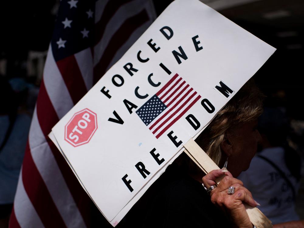 Vaccine protesters hold signs outside Houston Methodist Hospital in Houston, Texas, on June 26. More than 150 employees either quit or were fired for declining the vaccine.