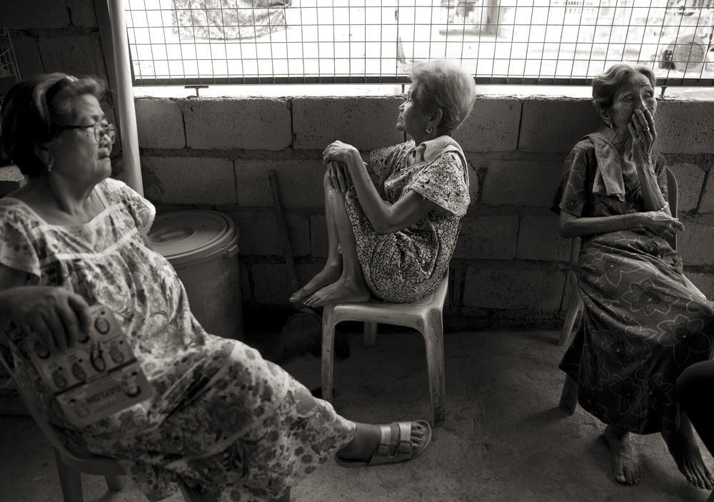 Candelaria Soliman, 91, Isabelita Vinuya, 88, and Emilia dela Cruz Mangilit, 92, left to right, were children when their village of Mapaniqui in Pampanga, Philippines, was attacked by the Japanese during World War II. All the men were killed and the women and girls were forced to walk to the Red House, where they were raped by Japanese soldiers.