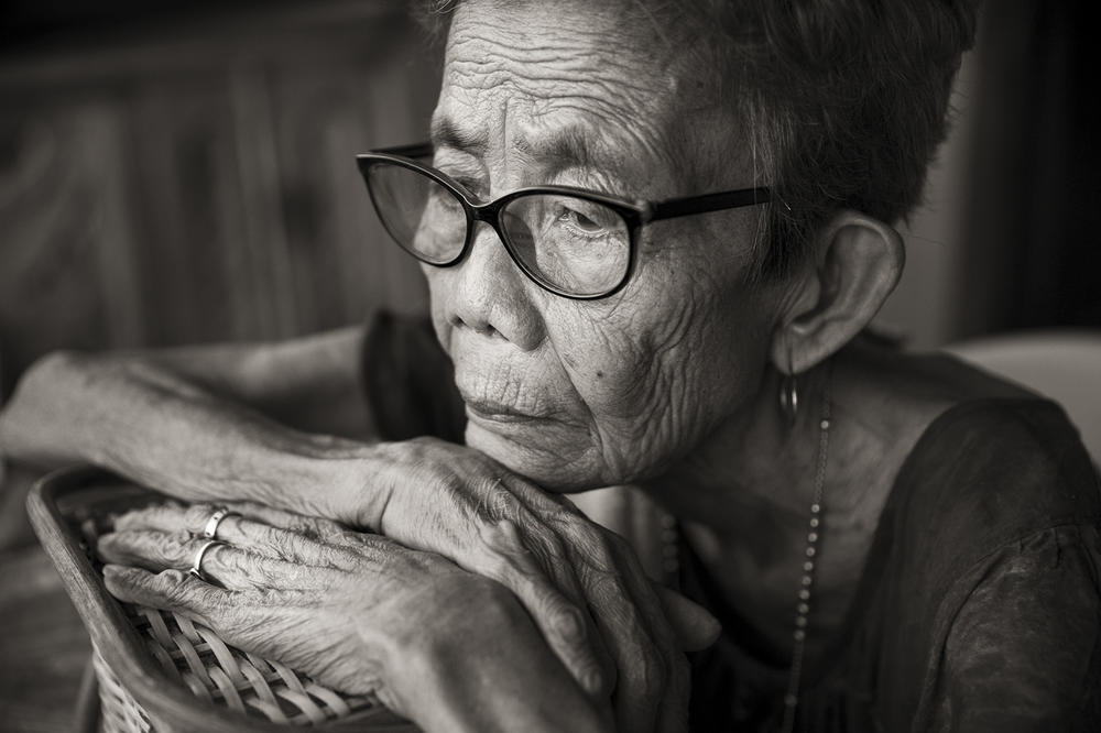 Belen Alarcon Culala looks out on the street in her village of Mapaniqui in Pampanga, Philippines. Culala, who died on Feb. 28, 2021, was one of approximately 100 girls and women who were raped repeatedly by the Japanese Imperial Army soldiers during the course of one night in World War II.