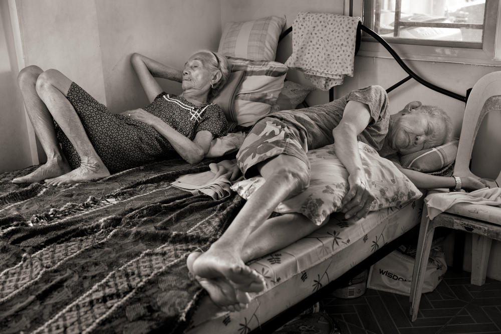 Narcisa Claveria takes a midday nap with husband, Anaceto Claveria, in their home in Antipolo, Metro Manila. Claveria was 12 years old in 1943 when the Japanese came to their village in Abra, Philippines, during World War II. Accused of harboring guerrilla fighters, her father was tortured and her mother was raped. Claveria never saw them again.