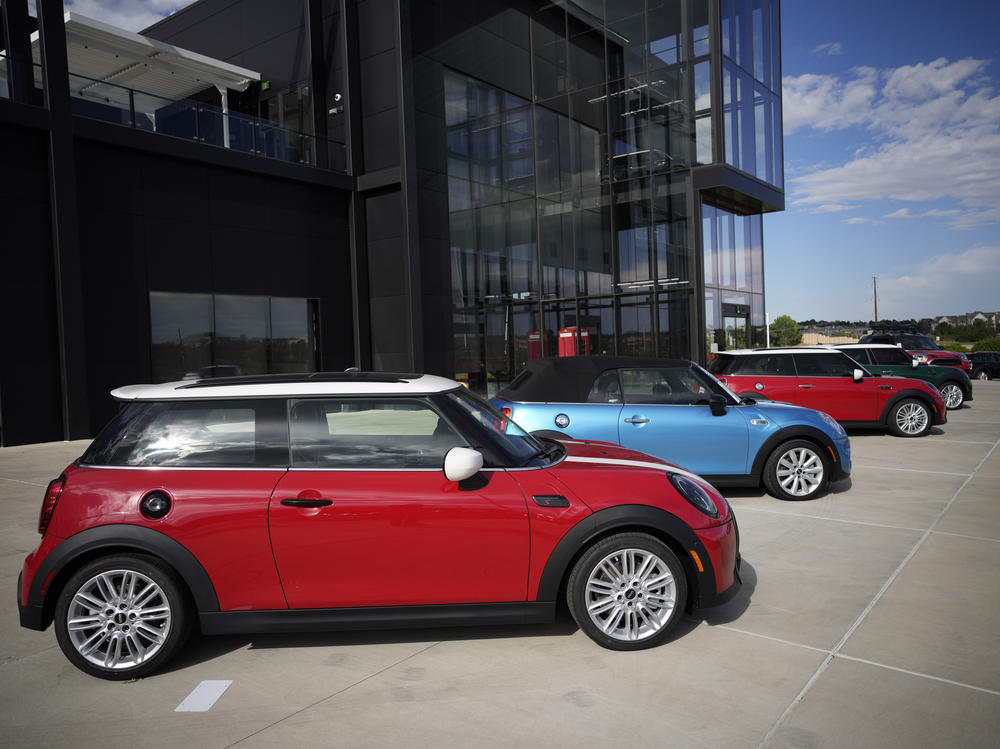 A small assortment of unsold 2022 models sits outside a Mini dealership in Highlands Ranch, Colo., on Sept. 12. Being flexible and staying patient are among the things to keep in mind if you are shopping for a car.