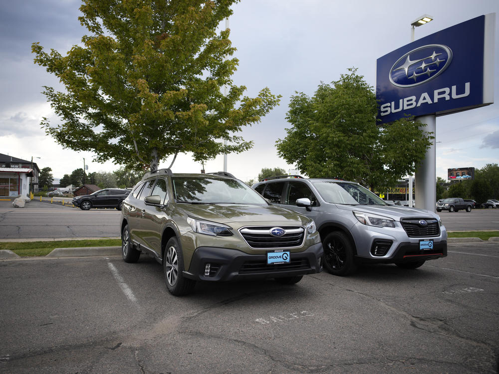 Two unsold 2021 Subaru SUVs sit in an otherwise empty storage lot at a Subaru dealership in Littleton, Colo., on Sept. 12. Ordering a car directly from an automaker can mean long waits, but doing so can be easier than finding a car you want at a dealer.