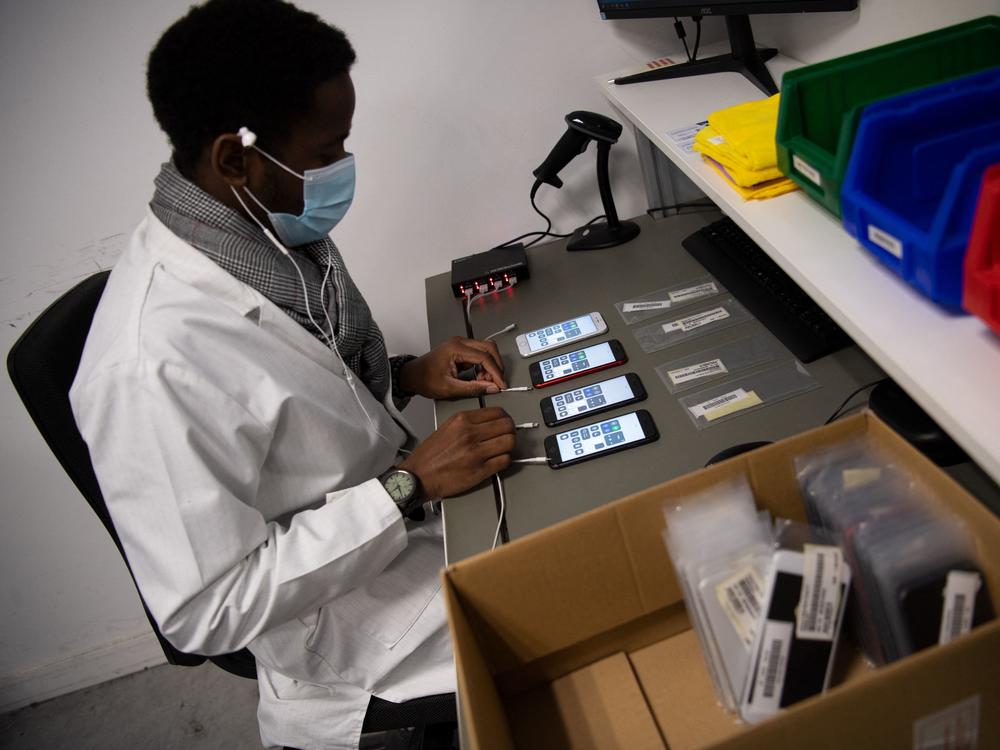 An employee works on smartphones reconditioning in France in January.