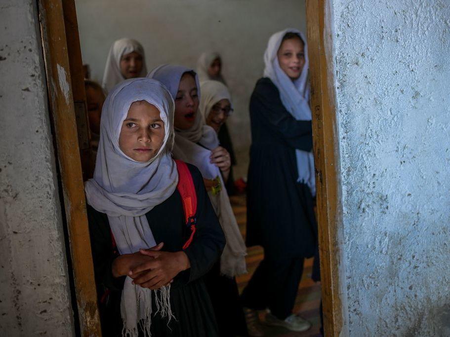 Girls gather at a gender-segregated school in Kabul on Sept. 15. When older secondary students returned to classes, female students were told to wait.