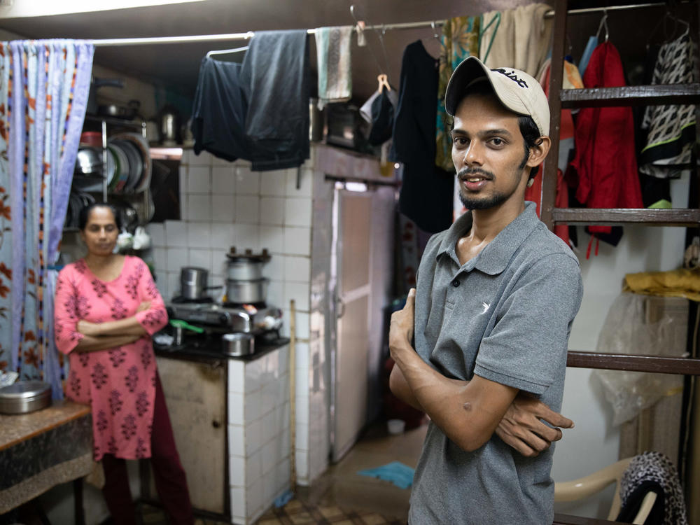 Salman Khan Rashid, 24, right, and his mother, Sana Rashid, at home. Salman lost his job as a golf coach at a Mumbai sports club during the pandemic. The household, which includes Salman's three sisters, is now surviving on savings. But when he's able, he'll give a little money or food to others facing food insecurity.