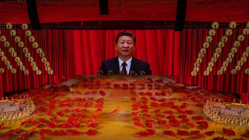 Chinese President Xi Jinping appears on a large screen as performers dance during a June gala marking the 100th anniversary of the Chinese Communist Party at the Bird's Nest stadium in Beijing.