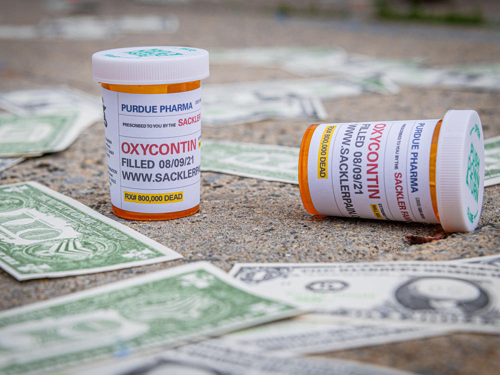 Demonstrators scatter fake money and prescription bottles of OxyContin in August outside of U.S. Bankruptcy Court in White Plains, where the Purdue bankruptcy hearings were held.