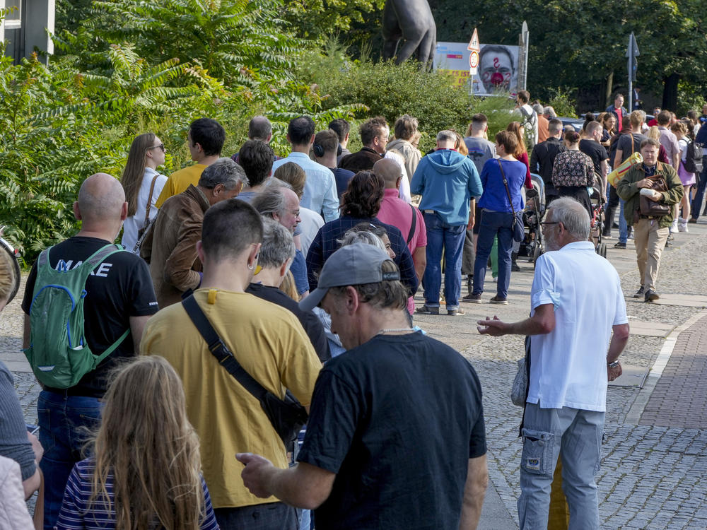 People queue in front of a polling station in the Moabit district of Berlin, Germany. German voters are choosing a new parliament in an election that will determine who succeeds Chancellor Angela Merkel after her 16 years at the helm of Europe's biggest economy.