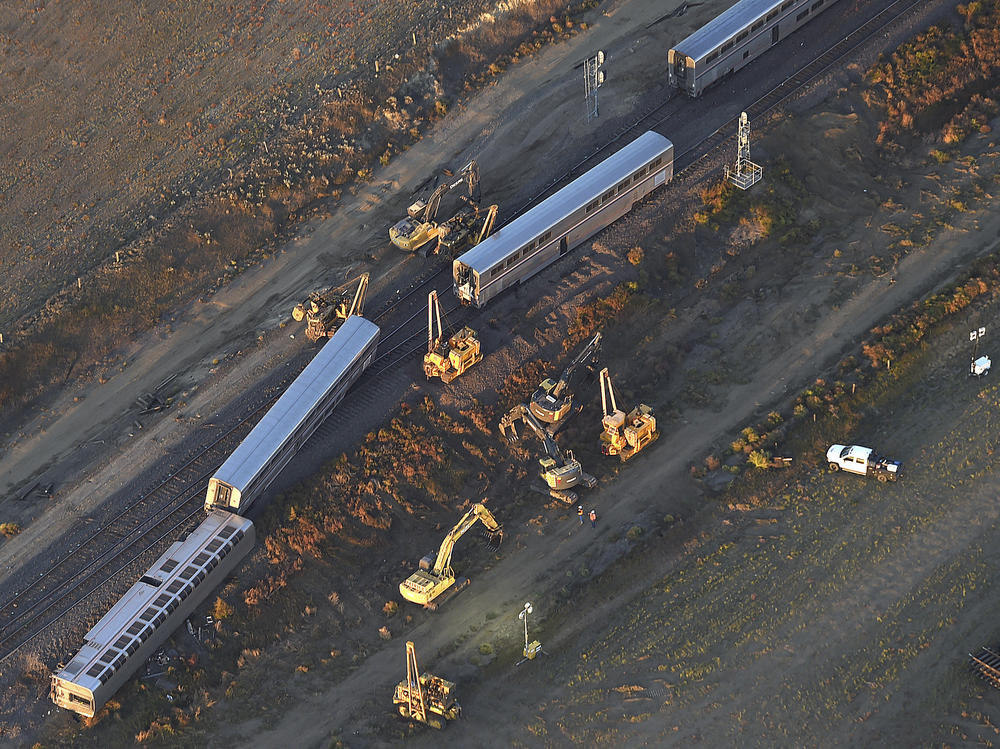 This aerial view taken Sunday, shows part of an Amtrak train that derailed in north-central Montana Saturday that killed multiple people and left others hospitalized, officials said. The westbound Empire Builder was en route to Seattle from Chicago, with two locomotives and 10 cars, when it left the tracks about 4 p.m. Saturday.