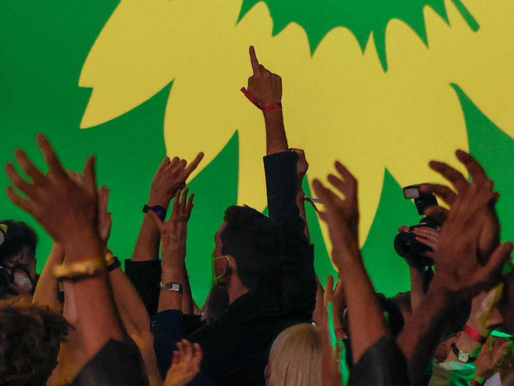 Supporters of Germany's Green Party celebrate after estimates were broadcast on television in Berlin at their electoral party on Sunday after the German general elections.