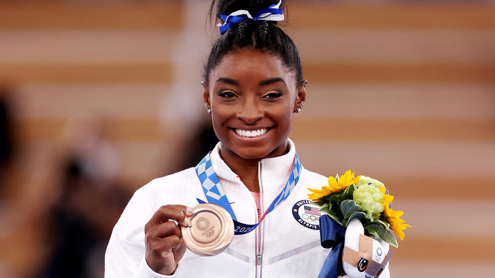 Simone Biles poses with the bronze medal during the Women's Balance Beam Final medal ceremony on day eleven of the Tokyo 2020 Olympic Games in August.