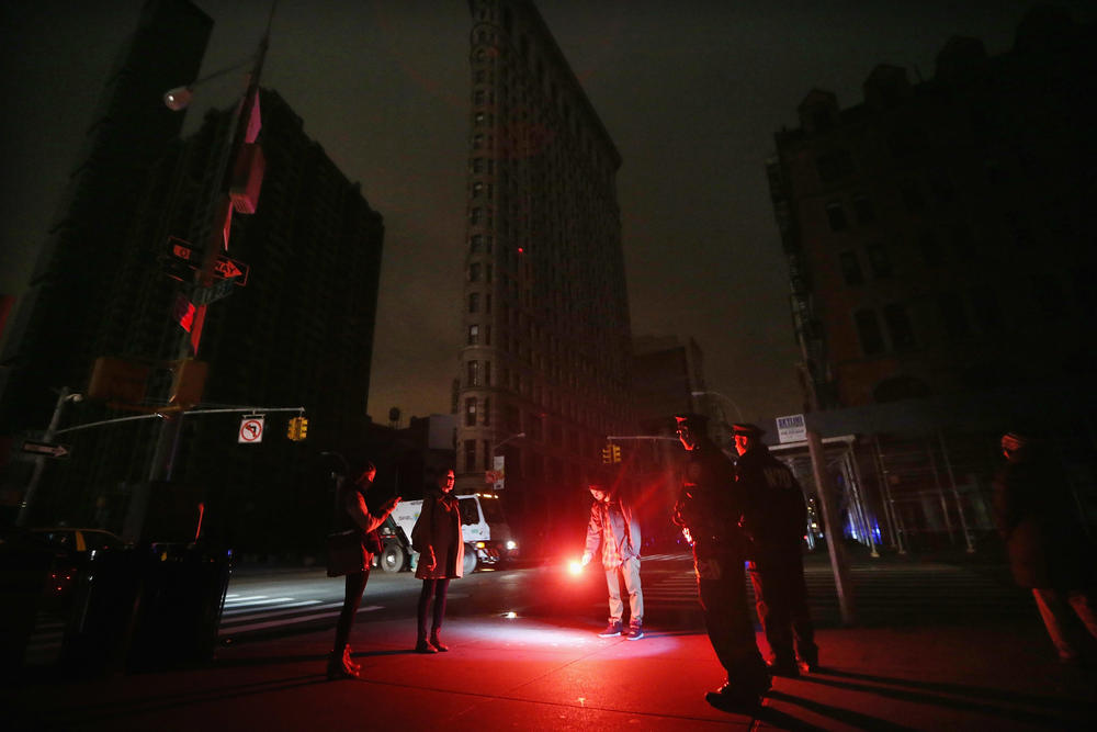 A road flare became an impromptu flashlight in front of a darkened Flatiron Building in Manhattan during a blackout following Hurricane Sandy in 2012.