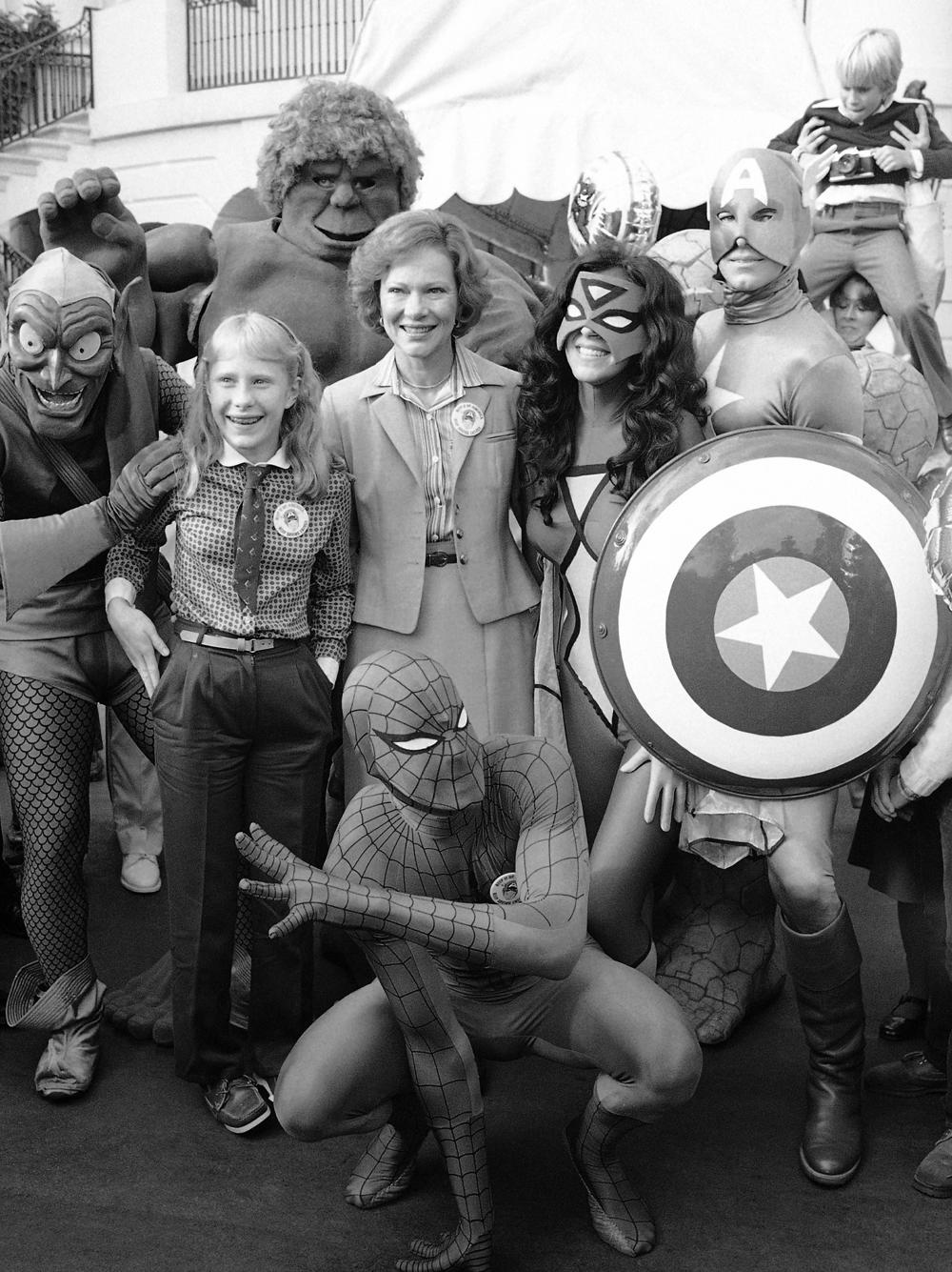 First lady Rosalynn Carter and daughter Amy are surrounded by comic book characters gathered at the White House in October 1980 to support President Jimmy Carter's program for energy efficiency.