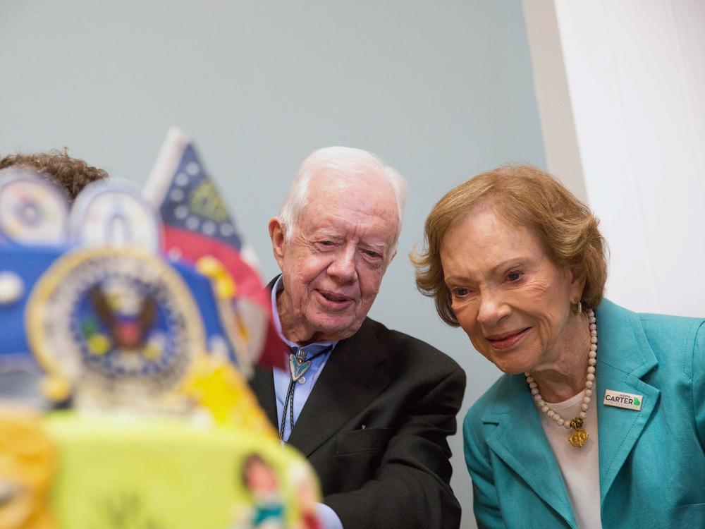 Former first lady Rosalynn Carter looks at a birthday cake with her husband, former President Jimmy Carter, during his 90th birthday celebration held at Georgia Southwestern University, Oct. 4, 2014, in Americus, Ga.