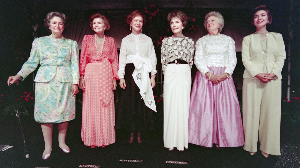 Former first ladies Lady Bird Johnson, Betty Ford, Rosalynn Carter, Nancy Reagan, Barbara Bush and first lady Hillary Clinton stand on stage, on May 11, 1994, during a gala event in their honor at the Botanic Garden Conservatory in Washington.