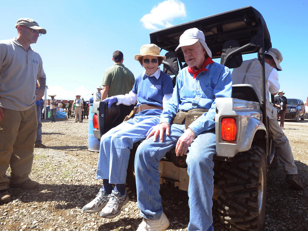 Former first lady Rosalynn Carter and her husband, Jimmy, take a break during a housing work project in Haiti in 2011 for victims of the massive Jan. 12, 2010, earthquake.