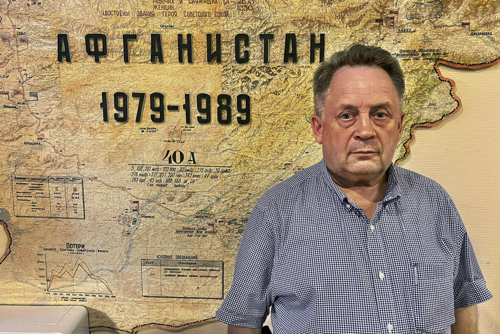 Sergei Opalev poses with a map of Afghanistan at the Union of Veterans of Afghanistan's office in Moscow. Opalev was among the last Soviet troops to withdraw in February 1989. 