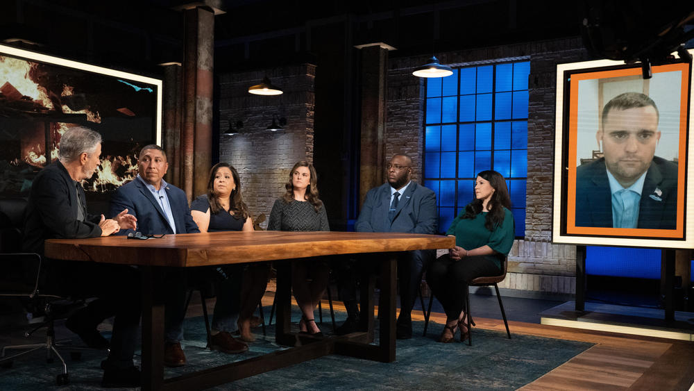 Jon Stewart with panelists Capt. Le Roy Torres (Ret.), Rosie Torres, Julie Tomaska, Sgt. Isiah James (Ret.), Gina Cancelino and Staff Sgt. Wesley Black (Ret.) on 