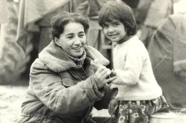 Mukhru Khodzhayeva with an unidentified child in an Afghan village during a humanitarian mission in 1987. A former interpreter for Soviet forces, she says, 