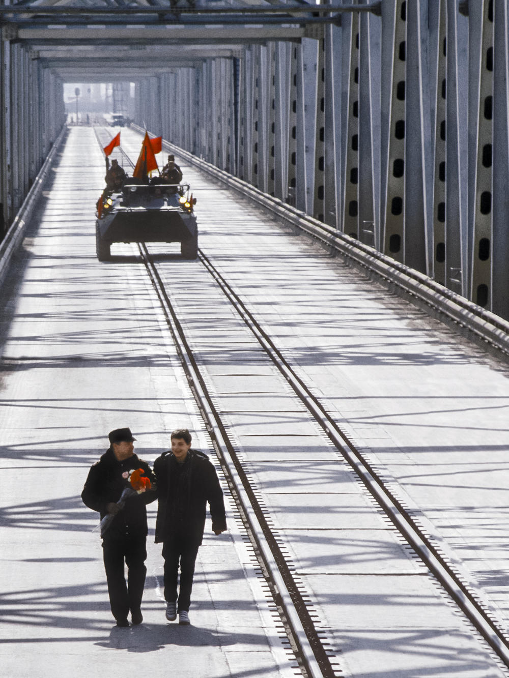 On Feb. 15, 1989, Lt. Gen. Boris Gromov (left), with his son, Maxim, walks across a bridge over the Amu Darya at Termez, Uzbekistan. When the Soviet Union completed its military withdrawal from Afghanistan, it was widely hailed as a much-anticipated end to a bloody quagmire, but public perceptions have changed.
