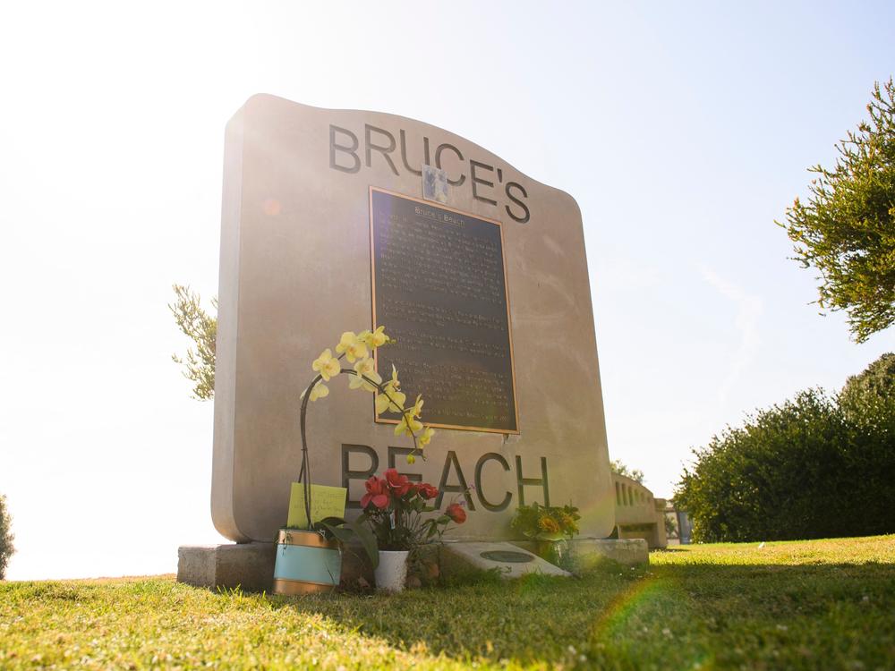 Flowers in support of the Bruce family and George Floyd stand at Bruce's Beach in April in Manhattan Beach, Calif.