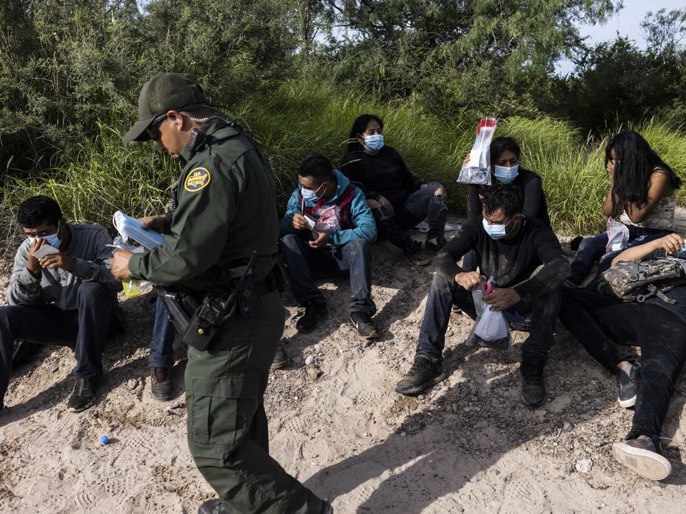 Migrants are apprehended by U.S. Customs and Border Protection agents in LaJoya, Texas, in June.