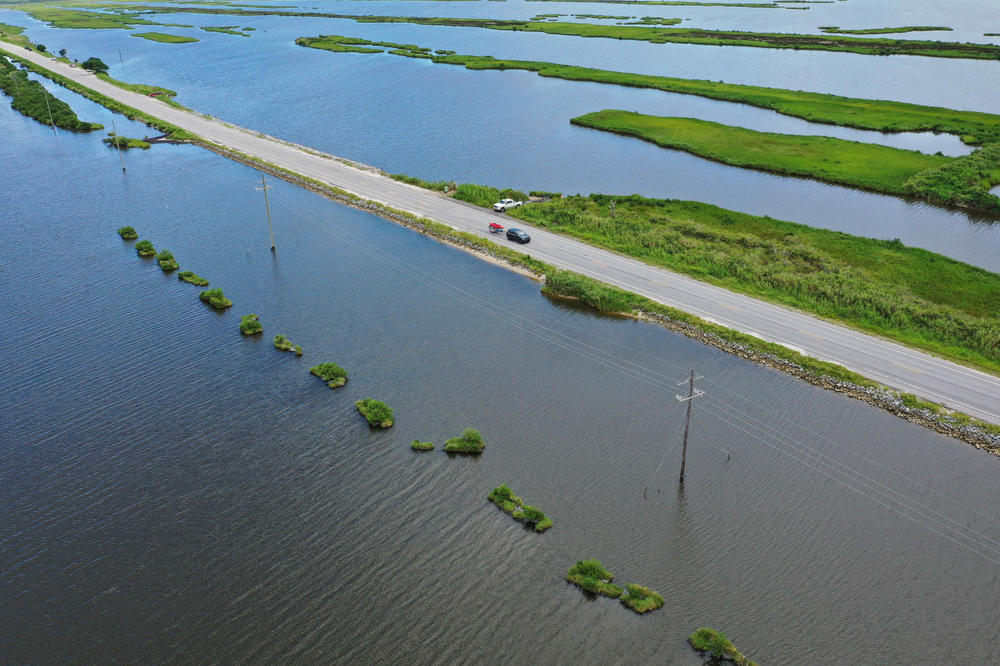 At left, a marsh creation project stands in the coastal waters near Louisiana Highway 1 on Aug. 24, 2019, in Grand Isle, La. New marsh has been created by the Coastal Conservation Association of Louisiana to create habitat and fortify marshland that had been devastated by years of erosion and storms.