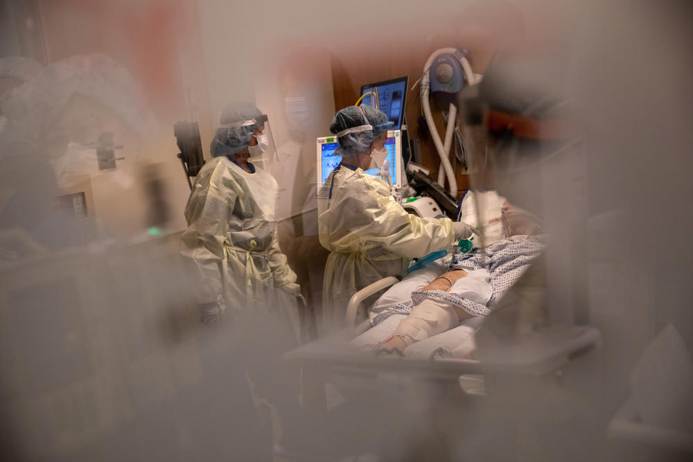 Nurses tend to a COVID-19 patient in an intensive care unit in 2020. Burnout was already an issue among health care workers prior to the pandemic, but short staffing and unpredictable workloads have exacerbated the problem.