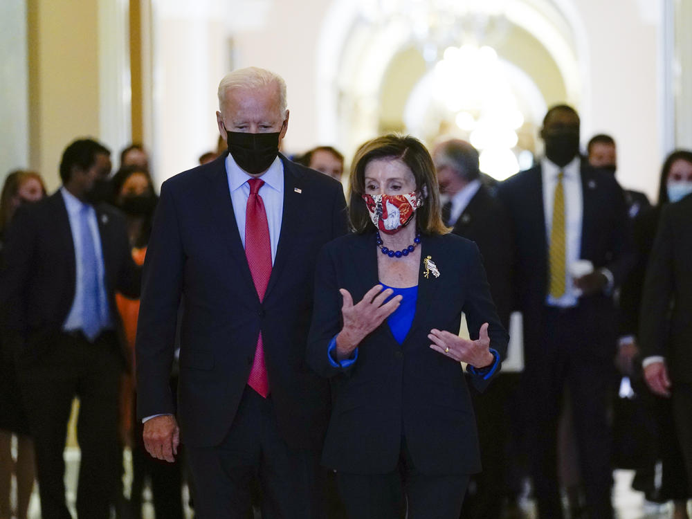 President Biden walks with House Speaker Nancy Pelosi on Capitol Hill on Friday after attending a meeting with the House Democratic Caucus to try to resolve an impasse around the bipartisan infrastructure bill.