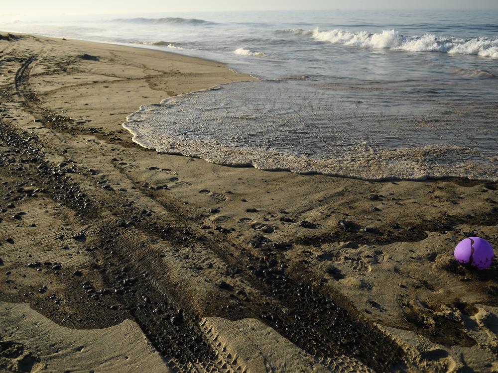 Oil is seen on the beach in Huntington Beach, California on October 3, 2021, after a pipeline breach connected to an oil rig off shore started leaking oil, according to an Orange County Supervisor.