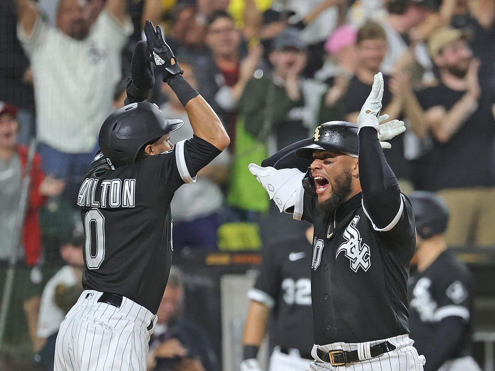 White Sox player Yoan Moncada (R) celebrates his two-run home run in the 8th inning with pinch runner Billy Hamilton against the Detroit Tigers on Saturday. The White Sox will play the Houston Astro in the ALDS.